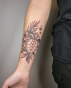 a person's arm with a tattoo on it that has fruit and leaves on it