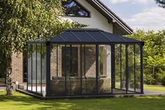 a house with a screened porch and glass walls