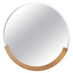 a round mirror with wood trim around the edges and a white background, reflecting light