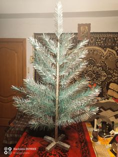 a small christmas tree sitting on top of a table