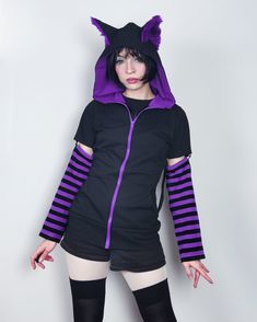 "𝘾𝘼𝙏 𝙀𝘼𝙍𝙎 𝙃𝙊𝙊𝘿𝙄𝙀 - 𝙋𝙐𝙍𝙋𝙇𝙀 - 𝙈𝘼𝙇𝙀 / 𝙁𝙀𝙈𝘼𝙇𝙀 𝘾𝙐𝙏 Black cat hoodie with ears. This cat ear hoodie has purple fur inside the standing cat ears. 𝗪𝗛𝗔𝗧 𝗪𝗜𝗟𝗟 𝗜 𝗥𝗘𝗖𝗘𝗜𝗩𝗘 ♥ Zip up hoodie ♥ Hood with cat ears (fur inside) ♥ Detachable sleeves (easy to apply!) ♥ Sleeves with thumbholes ♥ Big pockets to hold your stuff :D 𝗙𝗔𝗕𝗥𝗜𝗖: Cotton sweatshirt, faux fur for the ears 𝗦𝗜𝗭𝗘: Male or female cut. Size chart you will find it on the last photo! For custom Emo Style Tops For Cosplay In Winter, Emo Style Tops For Winter Cosplay, Emo Cotton Hoodie For Winter, Emo Hooded Winter Hoodie, Winter Emo Cotton Hoodie, Harajuku Style Cosplay Tops For Winter, Casual Purple Hoodie For Halloween, Harajuku Style Winter Tops For Cosplay, Harajuku Style Tops For Winter Cosplay