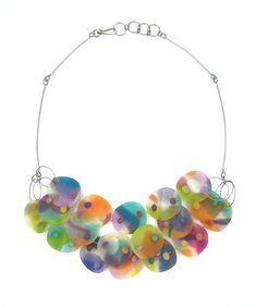 a multicolored necklace is hanging from a silver chain