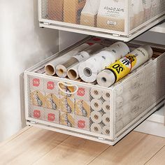 two white bins filled with different types of items on top of a wooden floor