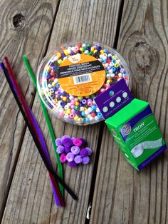 there are some candy and toothbrushes on the wooden table next to each other