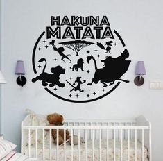 a wall decal that says hakuna matata with silhouettes of pooh, eeo and other disney characters