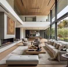 a large living room with couches, tables and fireplace in the middle of it