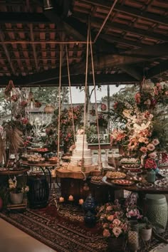 a table with flowers and cakes on it