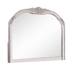 a white mirror with an ornate design on the top and bottom frame, against a white background