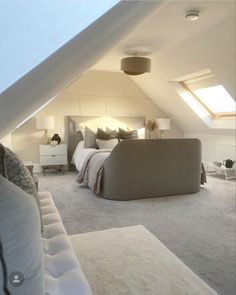 an attic bedroom with white walls and carpet