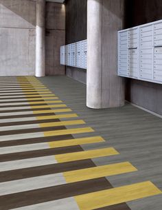 a row of mail boxes sitting next to each other on top of a cement floor