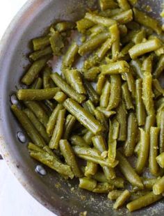 some green beans are in a pan on the stove top, ready to be cooked