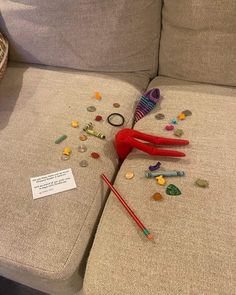 a pair of red scissors laying on top of a couch next to some confetti