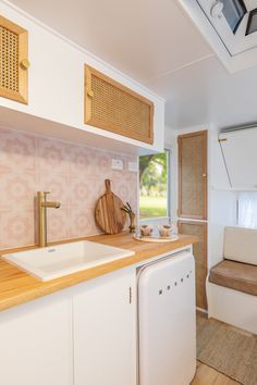 a kitchen area with sink, dishwasher and window