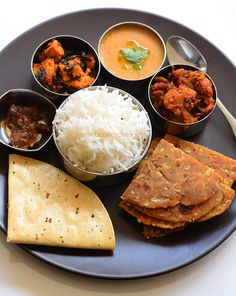 a black plate topped with different types of food