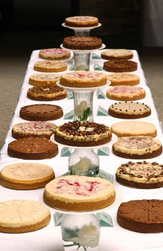 a table topped with lots of different types of cakes and pies on top of it