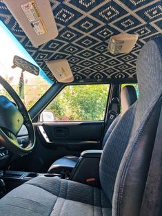 the interior of a vehicle with an upholstered ceiling and dash board on it