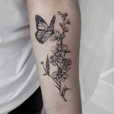 a butterfly and flowers tattoo on the arm