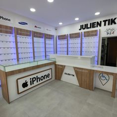 the inside of an apple store with multiple displays on the wall and below glass counter tops