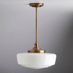 an antique brass and white glass pendant light