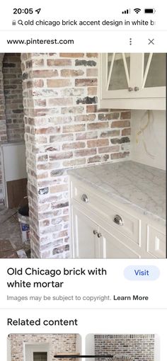 an old brick wall is being remodeled with white paint and new cabinets in the kitchen