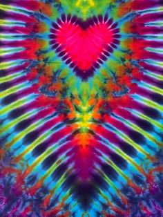 a tie - dyed background with a heart in the center