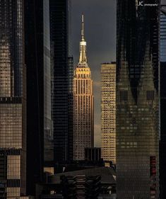 the empire building is lit up at night in new york city