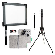 a tripod, camera and other items are arranged in front of a white background