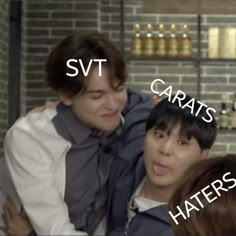 two young men hugging each other in front of a brick wall with words that read svt, garats, haters