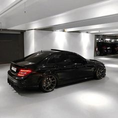 a black car parked in a parking garage