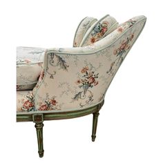 an upholstered chair with floral fabric on the back and arm rests against a white background