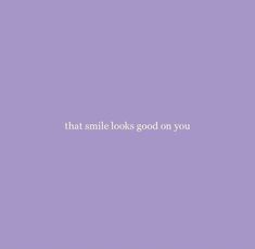 a purple wall with the words that smile looks good on you written in white letters