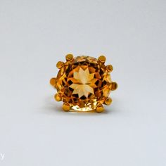 A lovely 10 carat oval citrine set in a wonderfully designed 18K yellow gold ring. The citrine is well cut has a great orangey color and is an immaculate looking stone.18K Yellow Gold Citrine 10tcw 16mm Band thickness 4.3mm Size 7.5 Resize available under request. Thank you for visiting our shop!Also, Follow us on Instagram https://www.instagram.com/dmkjewelryny/ Yellow Topaz Ring, 18k Yellow Gold Ring, Yellow Gold Ring, Topaz Ring, Cocktail Ring, Yellow Gold Rings, Cocktail Rings, Citrine, Gold Ring