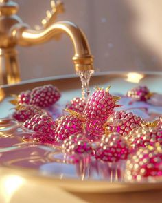 a sink filled with lots of pink and gold beads next to a faucet