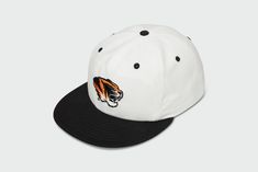 Introducing your new game day essential. Show your school spirit and represent the Mizzou Tigers with this versatile and stylish 90s white hat. Perfect for students, alumni, and fans alike. Made from all-natural, 100% cotton duck, this five panel hat is sure to keep your noggin cool and airy all summer long. 100% Duck Cotton Matching red undervisor Vintage Lightly Structured Fit Snap back closure Medium Crown One Size Fits Most Adults (6 7/8 to 7 3/4) Made in the USACut and Sewn in Kansas City, White 5-panel Baseball Cap For Baseball Season, White Curved Brim Trucker Hat For College, White 5-panel Snapback Hat, White Hip Hop Hat For Streetwear, Retro White Six-panel Trucker Hat, White Throwback Baseball Cap For Sports Events, White Snapback Trucker Hat For Streetwear, White Sporty Trucker Hat With Flat Brim, White Flat Bill Trucker Hat For Streetwear