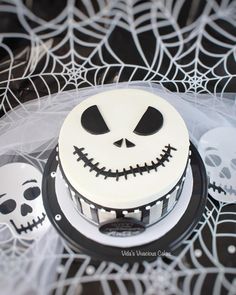 a cake decorated with white frosting and black icing