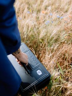 a person in a field with a suitcase