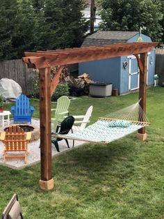 a backyard with lawn furniture and a hammock