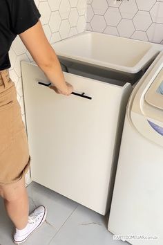 a person standing in front of a washing machine