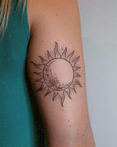 a woman with a sun tattoo on her arm