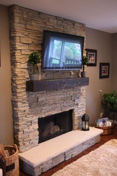 a living room with a fireplace and tv mounted on the wall above it's mantle