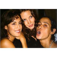 three women are posing for the camera with their mouths open