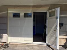 an open garage door in front of a house with no one inside or outside it