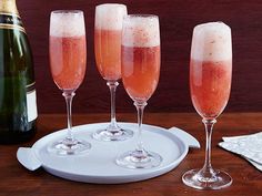 three champagne flutes are sitting on a plate