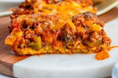 a slice of lasagna sitting on top of a cutting board