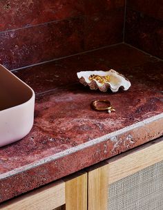 a close up of a bathroom sink near a counter top with an object on it