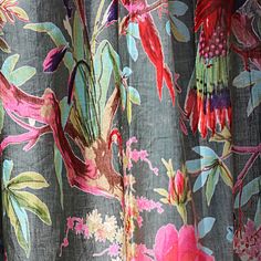 the curtain is decorated with colorful flowers and birds on grey background, closeup view