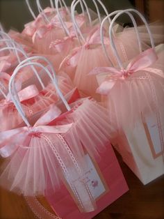 several bags with pink tulle and bows on them