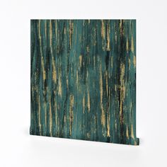 a piece of wood that has been painted with green and gold paint on the surface