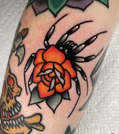 a close up of a person's arm with tattoos on it and a flower