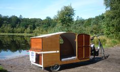 a bike is parked next to a small trailer